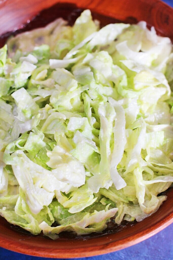 Crispy, fresh iceberg lettuce is topped with a creamy, buttermilk gorgonzola salad dressing for this Northwoods Inn Copycat recipe.