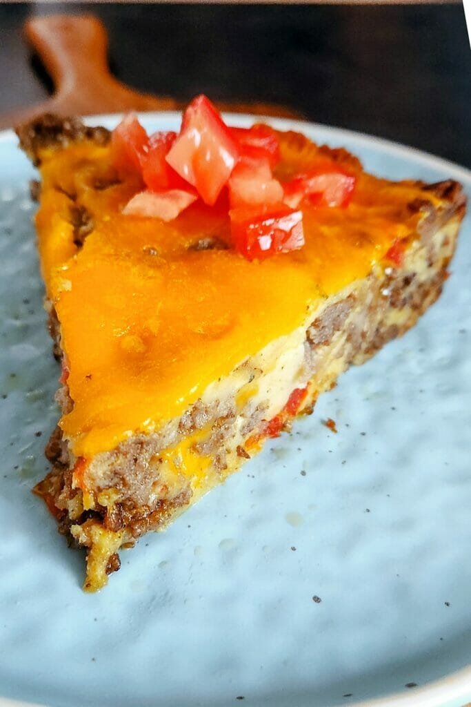 'Impossibly Easy' Bisquick Cheeseburger Pie slice on a blue plate