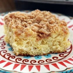 A slice of moist Pineapple Coffeecake with a golden streusel topping, served on a plate with a fork. Perfect for brunch or breakfast. #PineappleCoffeecake #StreuselTopping #BrunchRecipes