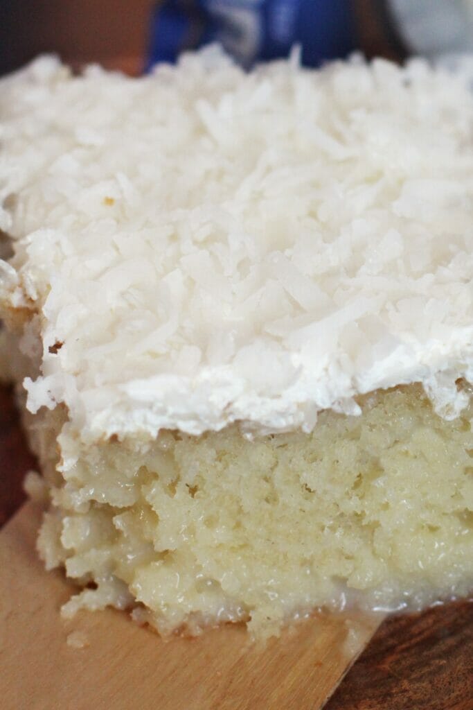 Slice of Ultra Moist Coconut Poke Cake